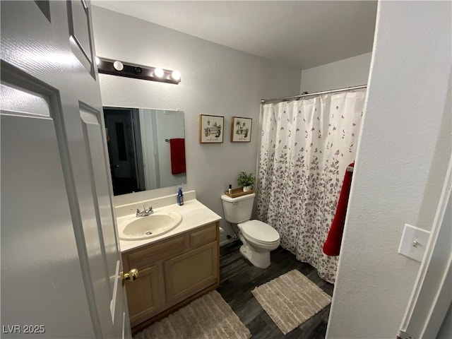 bathroom featuring hardwood / wood-style flooring, vanity, and toilet