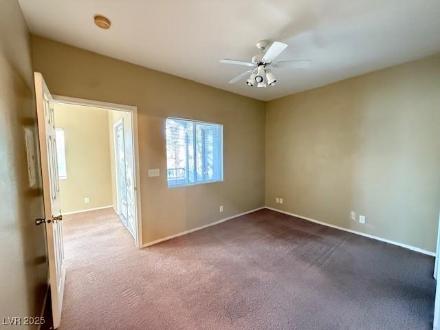 carpeted empty room featuring ceiling fan