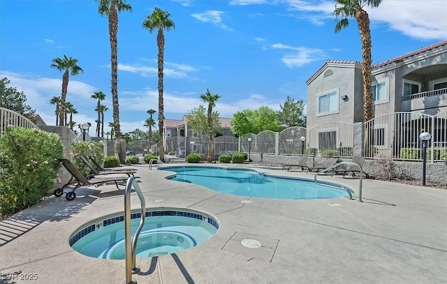 view of swimming pool featuring a hot tub