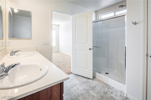 bathroom featuring an enclosed shower and vanity