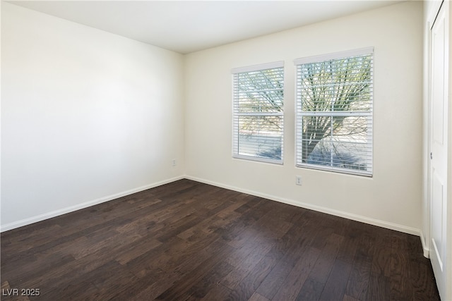 empty room featuring dark hardwood / wood-style flooring