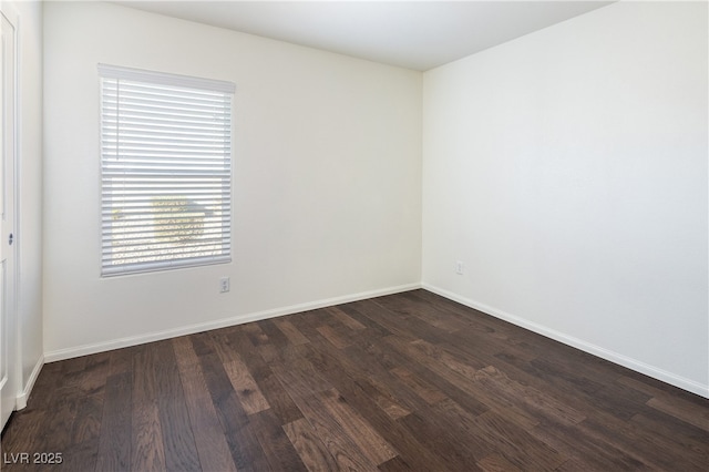 empty room with a healthy amount of sunlight and dark wood-type flooring