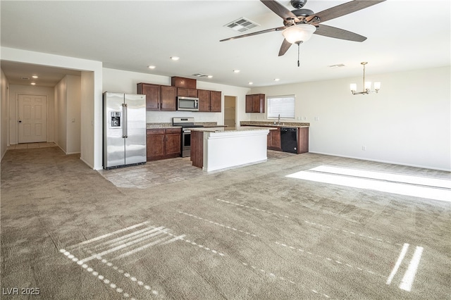 kitchen with a center island, hanging light fixtures, light colored carpet, ceiling fan with notable chandelier, and appliances with stainless steel finishes