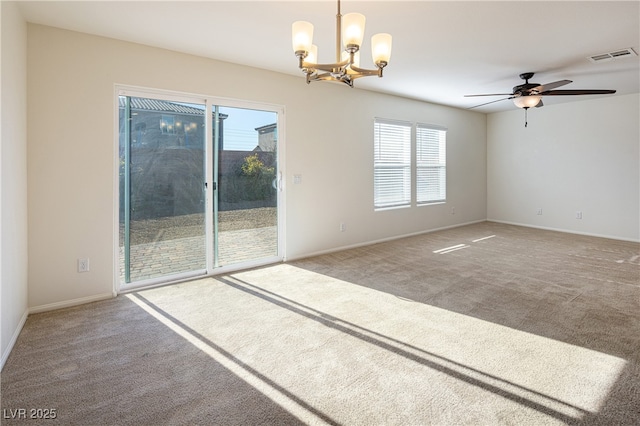 unfurnished room with carpet and ceiling fan with notable chandelier