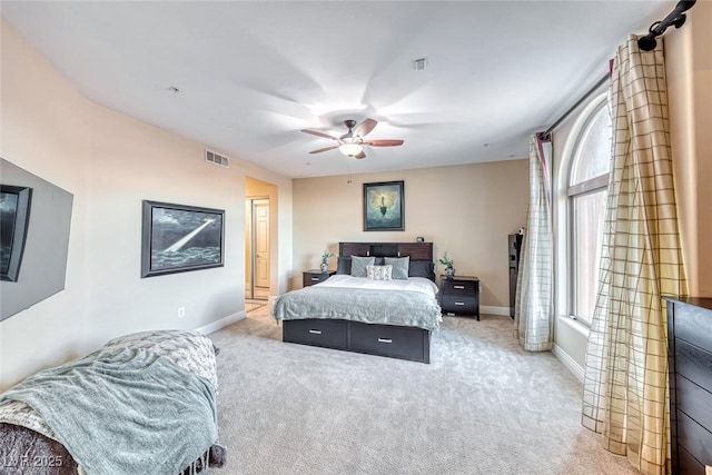 bedroom with ceiling fan and light colored carpet