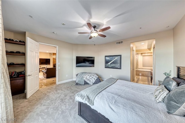 bedroom featuring connected bathroom, ceiling fan, and light colored carpet