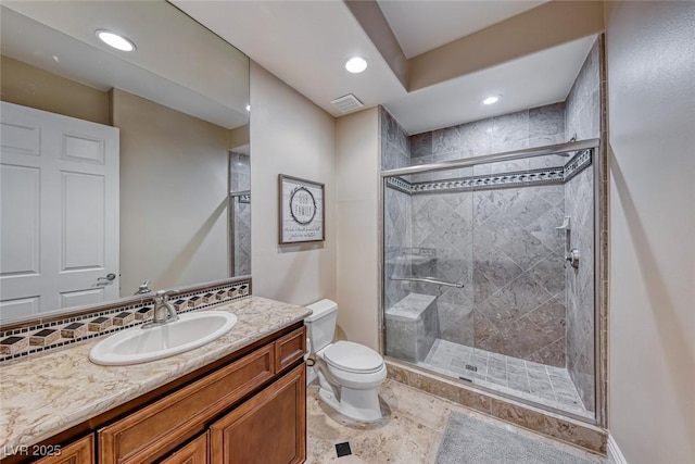 bathroom with toilet, a shower with door, and vanity