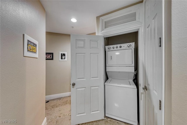 laundry room featuring stacked washer / dryer