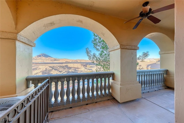 balcony with ceiling fan and a mountain view