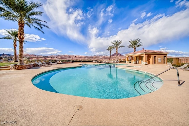 view of pool featuring a patio and a mountain view