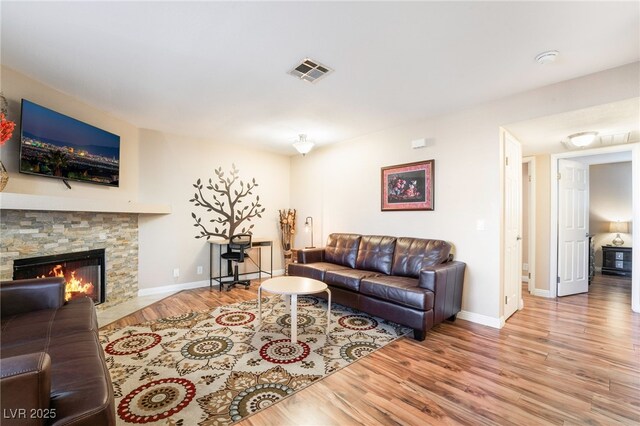 living room featuring a fireplace and wood-type flooring