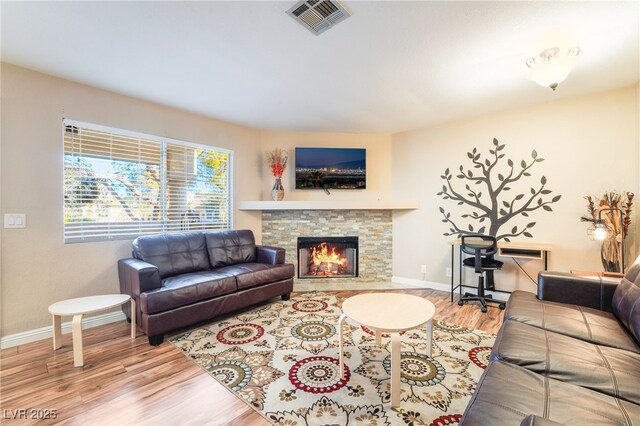 living room with a fireplace and hardwood / wood-style flooring