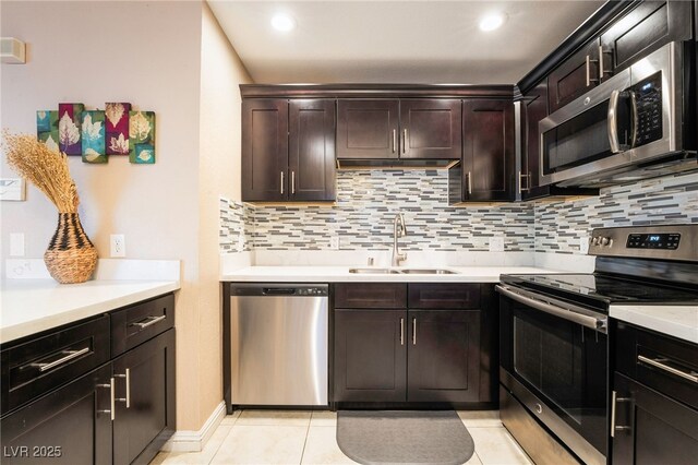 kitchen with decorative backsplash, light tile patterned floors, dark brown cabinets, and appliances with stainless steel finishes