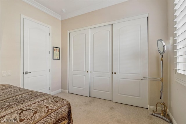 bedroom with ornamental molding, light colored carpet, and a closet