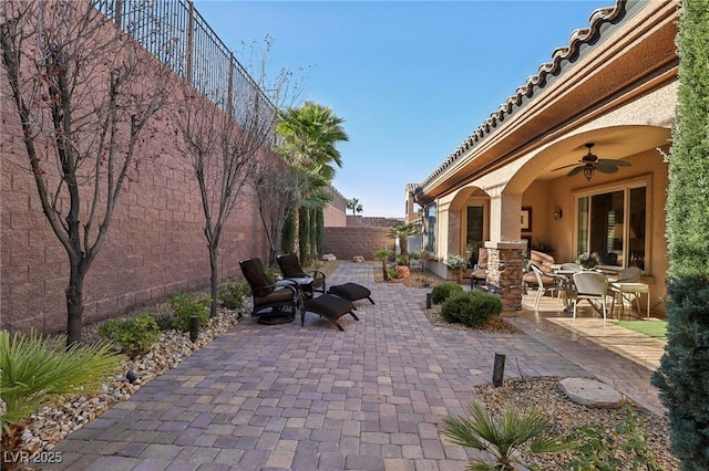 view of patio featuring ceiling fan