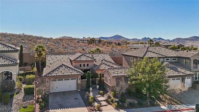 view of front of property with a garage and a mountain view