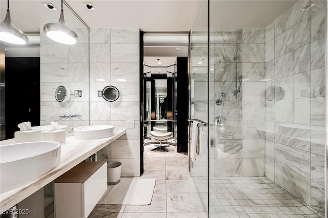 bathroom with tile walls, walk in shower, and vanity