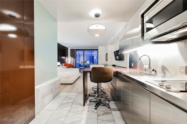 kitchen with sink, pendant lighting, and electric stovetop