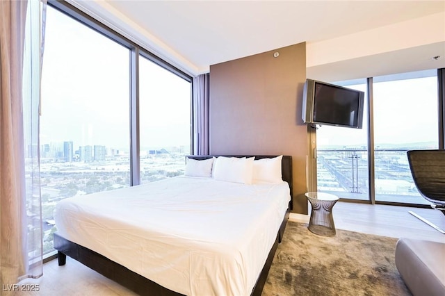 bedroom with light hardwood / wood-style flooring and multiple windows