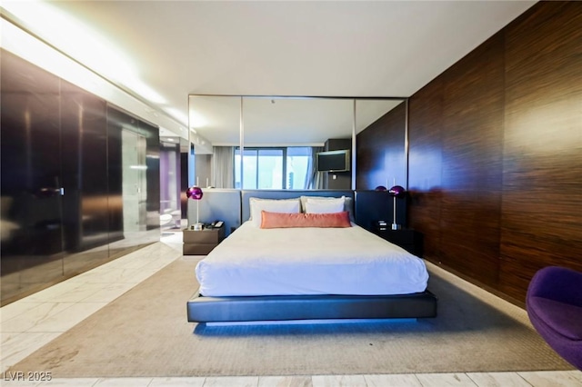 bedroom featuring wooden walls