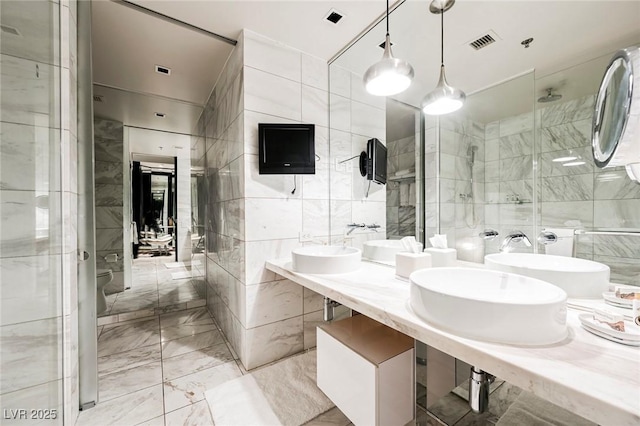 bathroom with tile walls and walk in shower