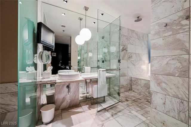 bathroom featuring tile walls, a shower with shower door, and vanity