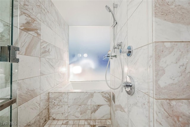 bathroom with a tile shower