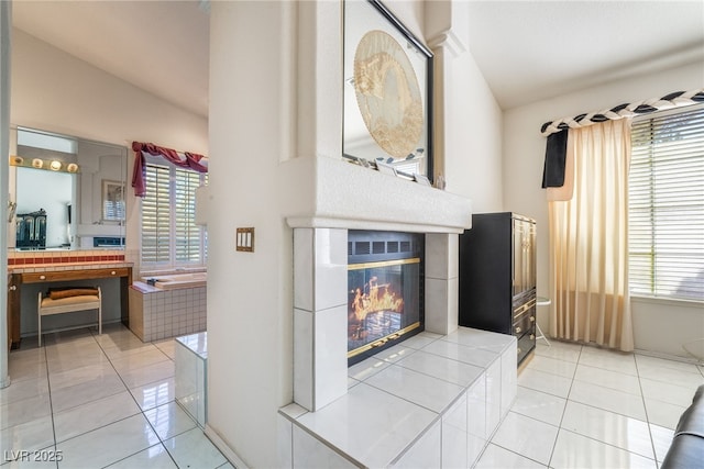 tiled living room with a fireplace and plenty of natural light