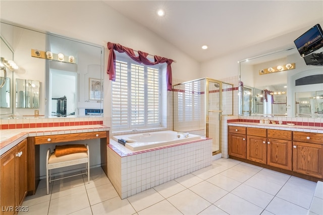 bathroom featuring independent shower and bath, vanity, and tile patterned floors