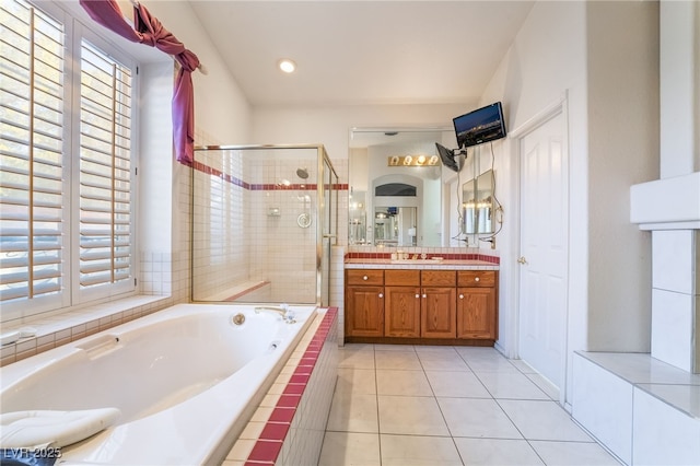 bathroom featuring shower with separate bathtub, vanity, and tile patterned flooring