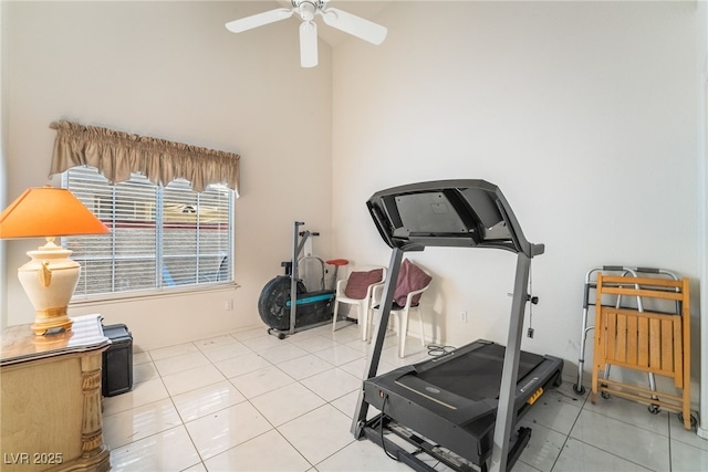 workout room with ceiling fan and tile patterned floors