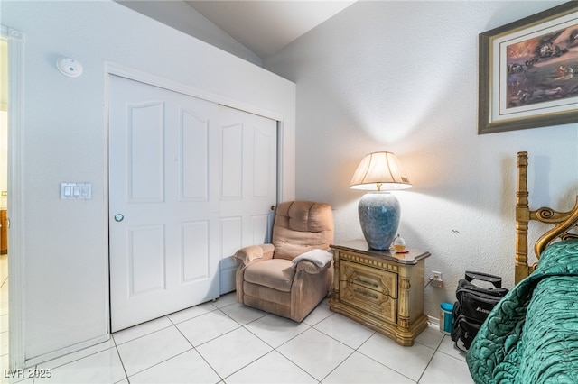 living area with vaulted ceiling and light tile patterned flooring