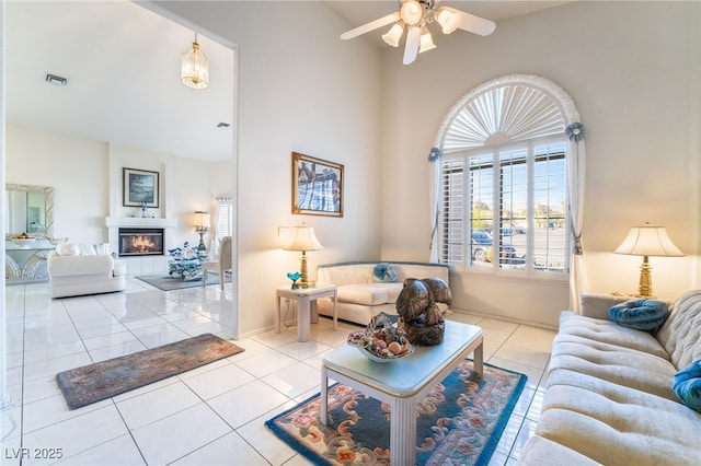 tiled living room with ceiling fan