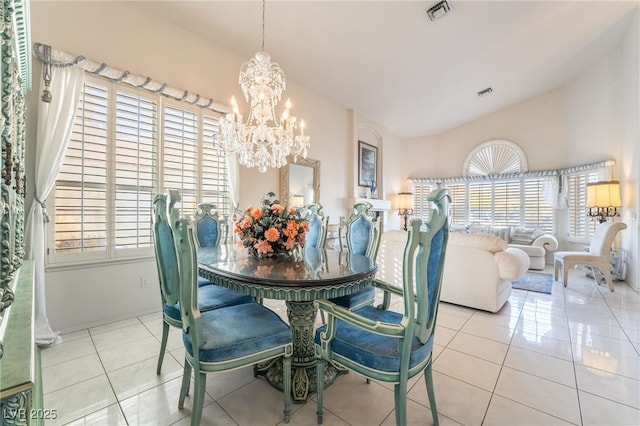 dining room featuring vaulted ceiling, a chandelier, and light tile patterned floors