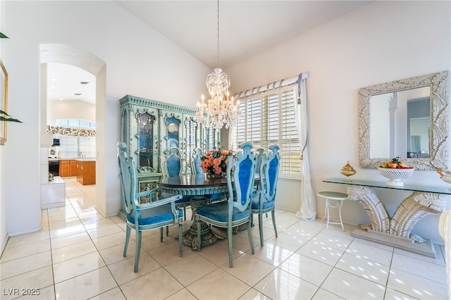 dining area featuring high vaulted ceiling, an inviting chandelier, and light tile patterned flooring