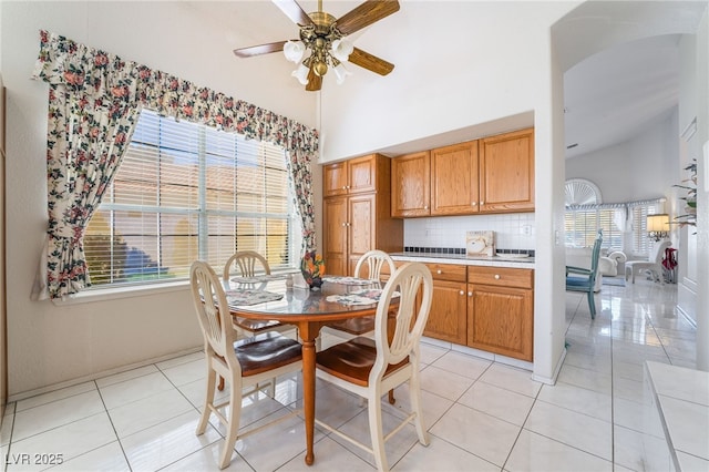 dining room featuring ceiling fan, light tile patterned floors, and plenty of natural light