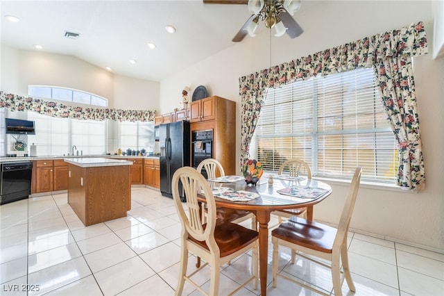 dining room with ceiling fan, sink, and light tile patterned floors