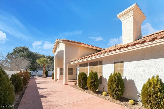 view of side of property featuring a patio area