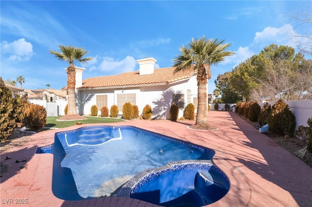 view of swimming pool featuring a patio area and an in ground hot tub