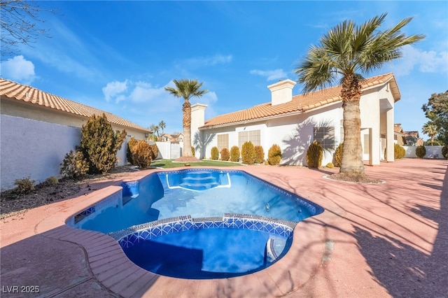 view of pool with a patio and an in ground hot tub