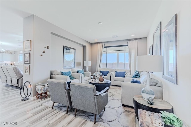 living room with light hardwood / wood-style floors and a chandelier