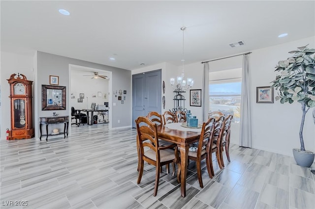 dining room featuring ceiling fan with notable chandelier