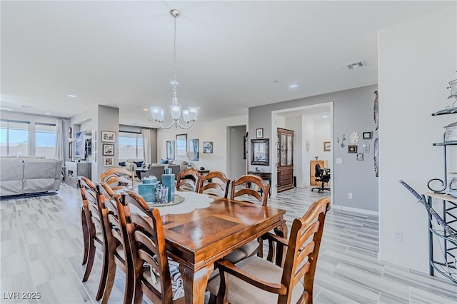 dining room featuring light hardwood / wood-style floors and an inviting chandelier