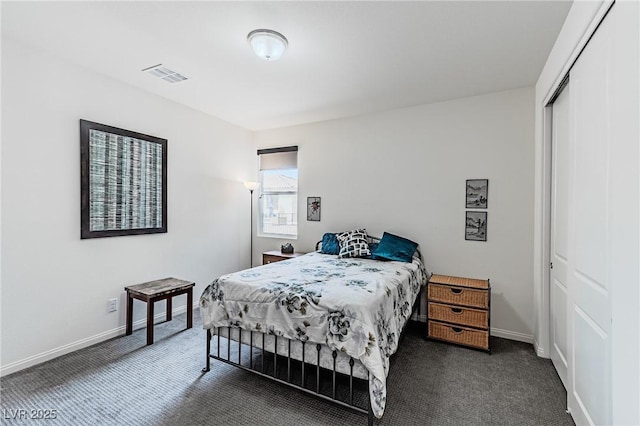 bedroom featuring dark colored carpet and a closet