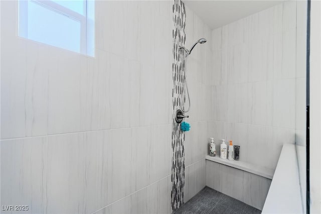 bathroom with a tile shower