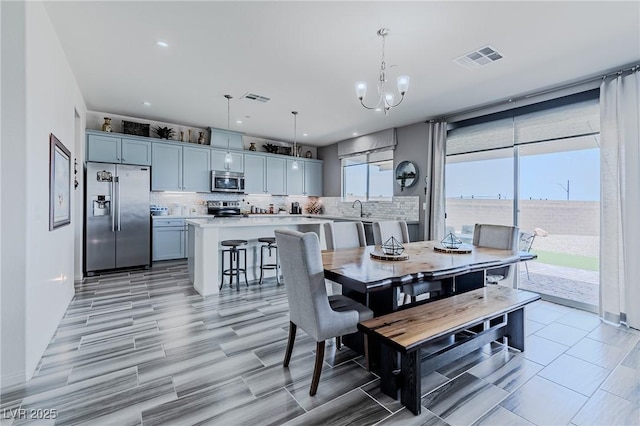 dining area featuring an inviting chandelier and sink