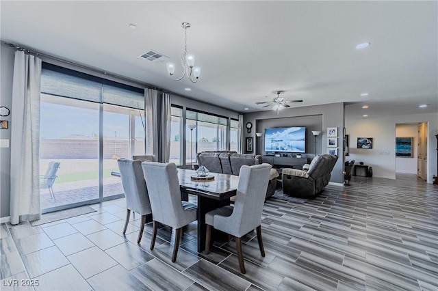 dining room with ceiling fan with notable chandelier