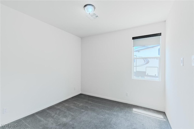 empty room featuring dark colored carpet