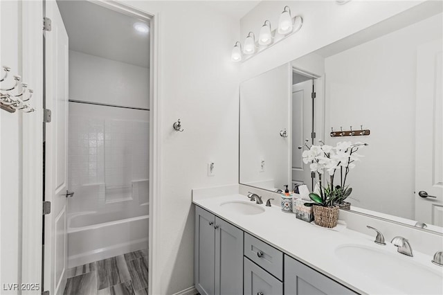 bathroom featuring wood-type flooring, vanity, and washtub / shower combination