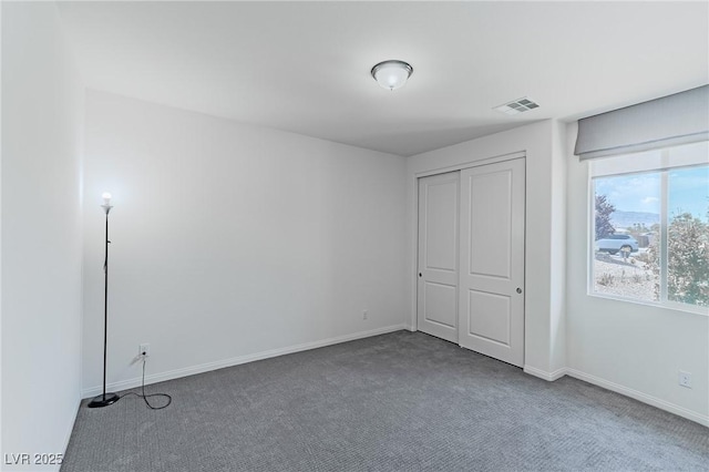 unfurnished bedroom featuring a closet and carpet